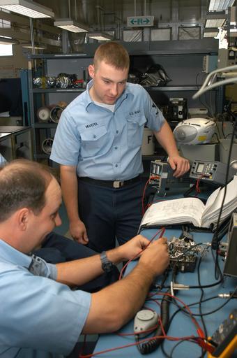 Navy 030520-N-2911P-004 Sailors troubleshoot an Inter-Communications Set (ICS) jack box.jpg en Misawa Japan May 20 2003 -- Aviation Electronics Technician 3rd Class William Martel standing from Medford Ore and Aviation Electrician's Mate ...