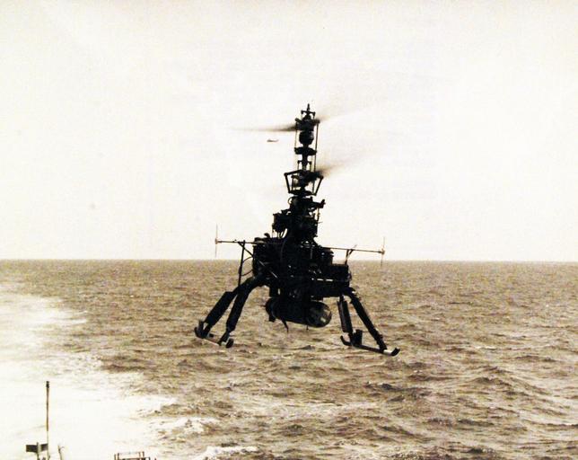 ...Drone Anti-Submarine Helicopter), hovers in free flight over the flight deck of USS Hazelwood (DD 531). Suspended under the drone’s body is a homing torpedo, mainstay of the DASH system. The drone, produced by Gyrodyne Company of America, ...