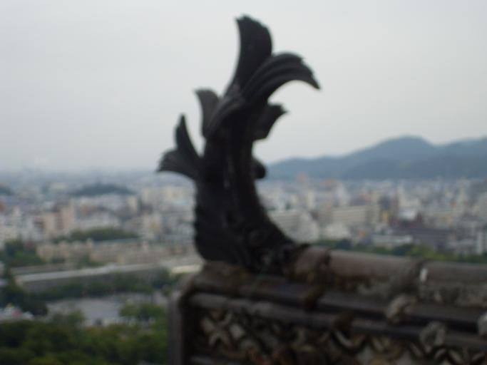 Shachihoko w Himeji.JPG Shachihoko a fish-shaped ornament on the roof of Himeji Castle Japan Own 2008-09-18 Wicki Shachi Himeji Castle Keep Tower